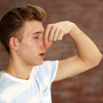 Man holding nose