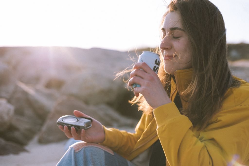 woman enjoying sent of beverage with dt lift  